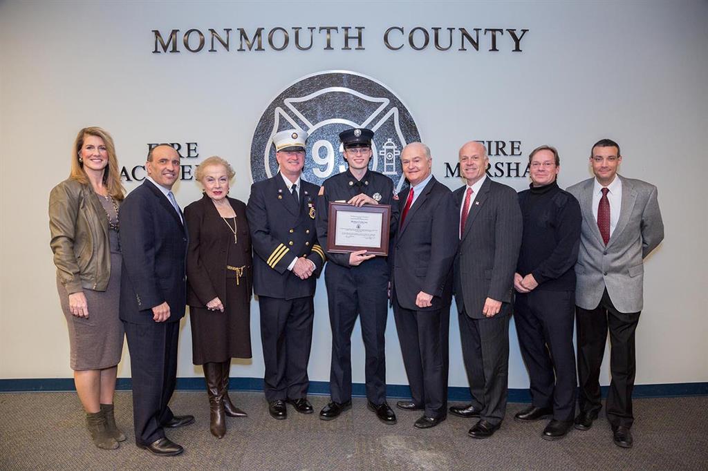Michael S. Giacona of Gordon’s Corner Fire Company in Manalapan is presented with the Class 109 Ronald Fitzpatrick Firefighter 1 Award at the Monmouth County Fire Academy graduation on Jan. 27, 2016 in Howell, NJ. Pictured left to right:  Freeholder Deputy Director Serena DiMaso, Freeholder Director Thomas A. Arnone, Freeholder Lillian G. Burry, Fire Marshal Kevin A. Stout, Michael S. Giacona, Freeholder John P. Curley, Freeholder Gary J. Rich, Sr., Steve Fitzpatrick and Fire Academy Director Armand Guzzi.